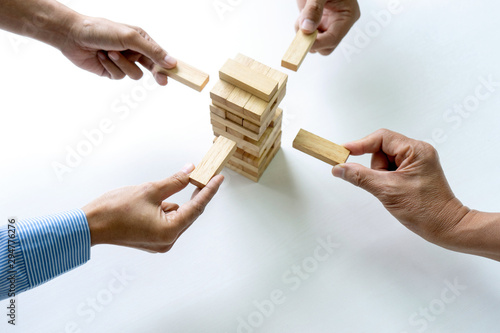 group of  Young businessman try to build wall and tower photo