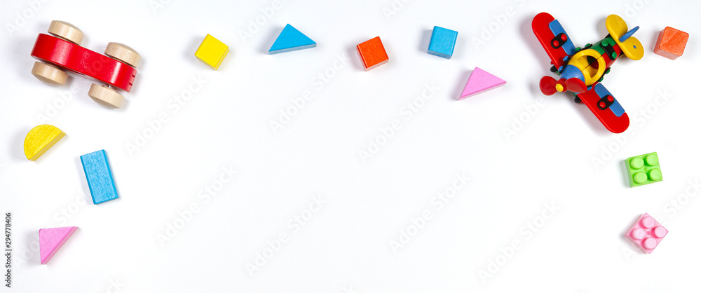 Baby kids toys on white background. Top view, flat lay. Copy space for text Baby kids toys on white background. Top view, flat lay. Copy space for text
