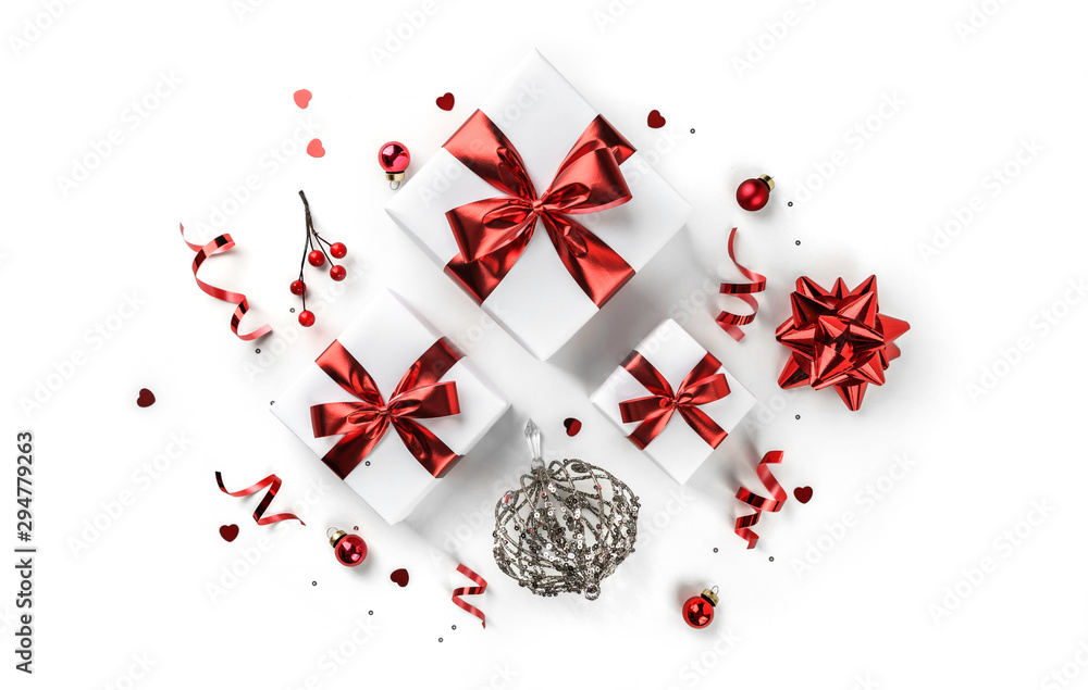 Christmas gift boxes with red ribbon and decoration on white background. Xmas and Happy New Year theme, snow. Flat lay, top view Christmas gift boxes with red ribbon and decoration on white background. Xmas and Happy New Year theme, snow. Flat lay, top view