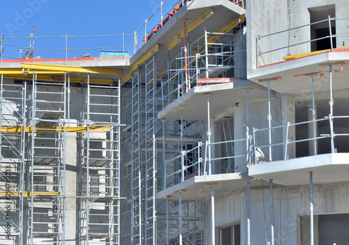 close on concrete facade with scaffolding of a residence in building on work place