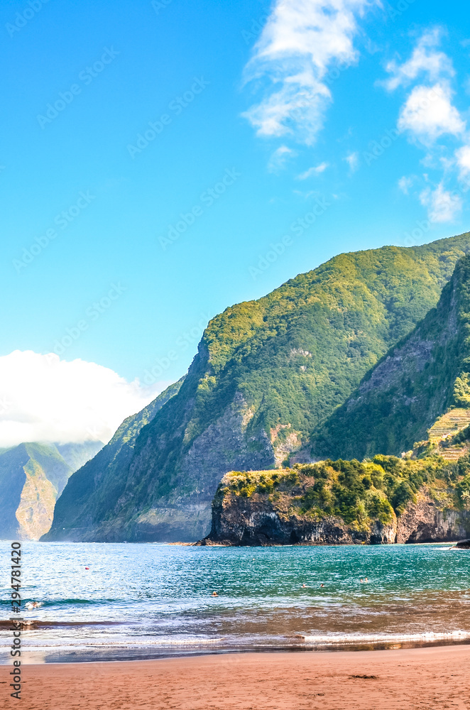Amazing sand beach in Seixal, Madeira Island, Portugal. Green hills