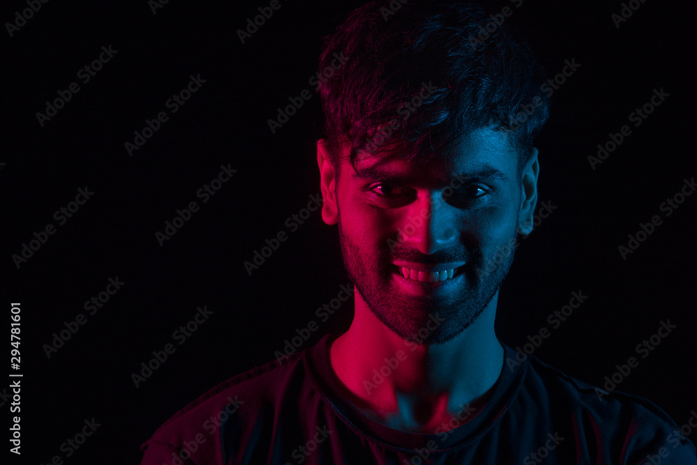 portrait of a man smiling in red and blue portrait of a man smiling in red and blue