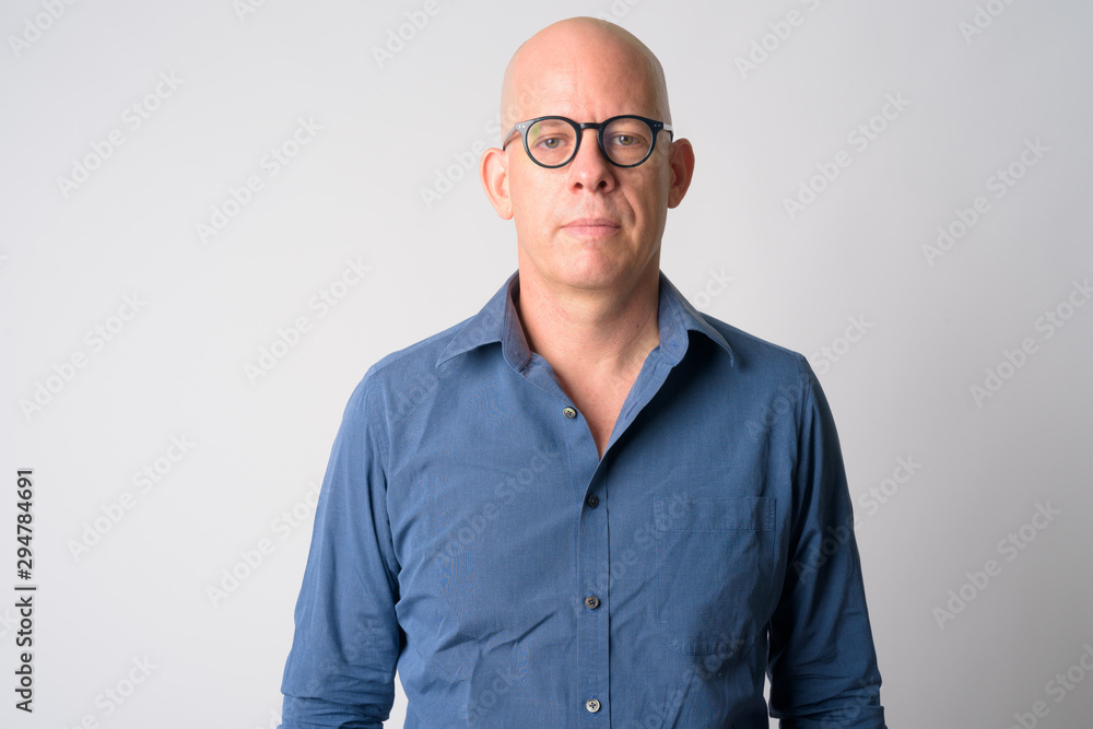 Portrait of mature handsome bald businessman with eyeglasses Portrait of mature handsome bald businessman with eyeglasses