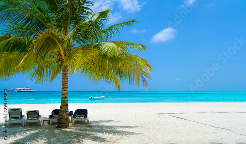 Lounge chairs on a beautiful tropical beach at Maldives