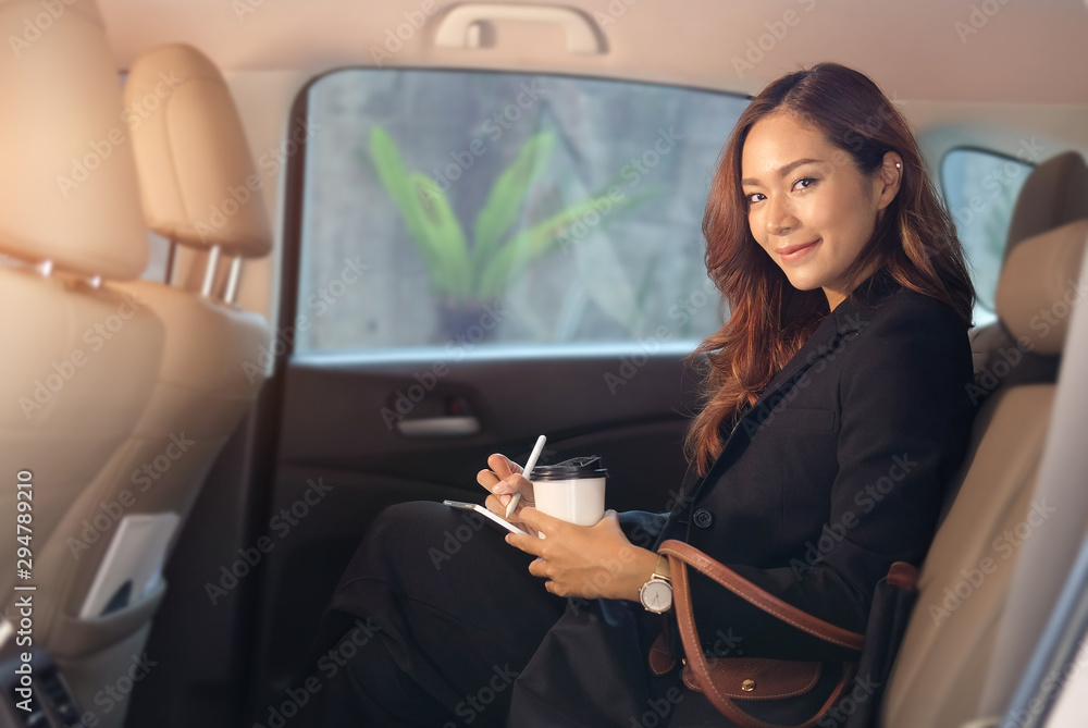 Close up portrait of a young business woman exiting a car