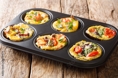 recipe for breakfast  egg muffins with vegetables  cheese  bacon and mushrooms close-up in a baking dish. horizontal