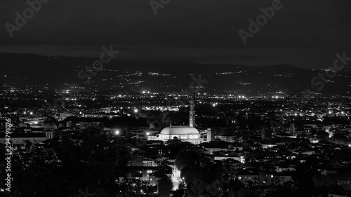 wide night panorama of the city of Vicenza and the famous monument called Basilica Palladiana with the tall Clock Tower. Vicenza, Veneto, Italy - October 3th, 2019 © Piero