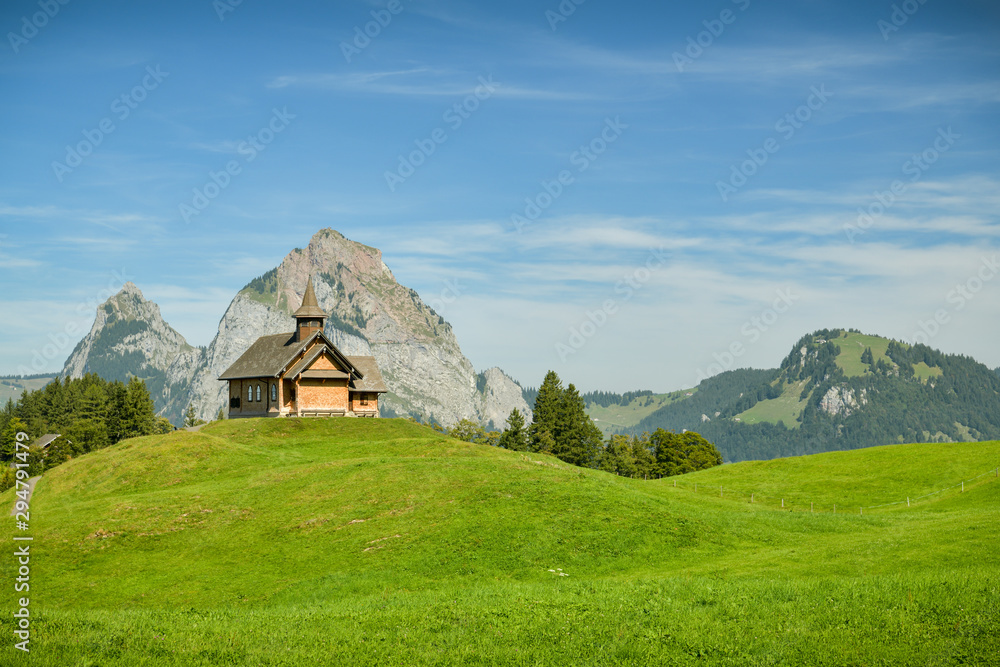 Beautiful wodden church and view on Grosser Mythen peak as seen from small village of Stoos, Switzerland