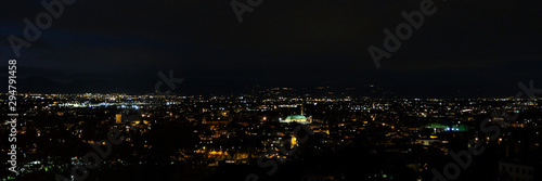 wide night panorama of the city of Vicenza and the famous monument called Basilica Palladiana with the tall Clock Tower. Vicenza, Veneto, Italy - October 3th, 2019