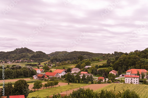 Wallpaper Mural Green hills and an old village in Slovenia. Traveling in Europe and tourism. Nature, sky and vineyards. Torontodigital.ca