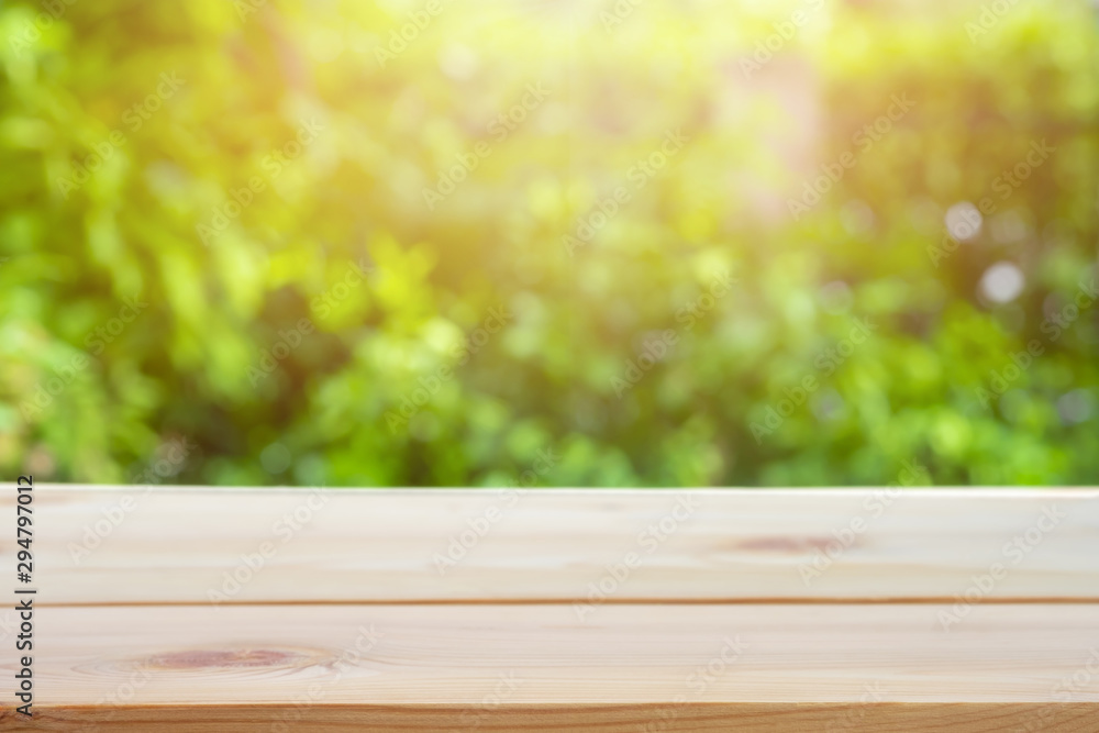 Perspective wooden table on top over blur natural background, can be used mock up for montage products display or design layout. Perspective wooden table on top over blur natural background, can be used mock up for montage products display or design layout.
