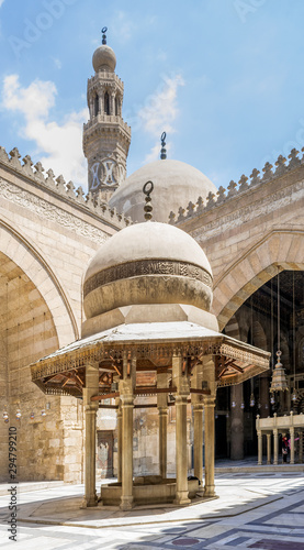 Ablution fountain at historic Sultan Barquq Mosque with dome and minaret in background, Cairo, Egypt