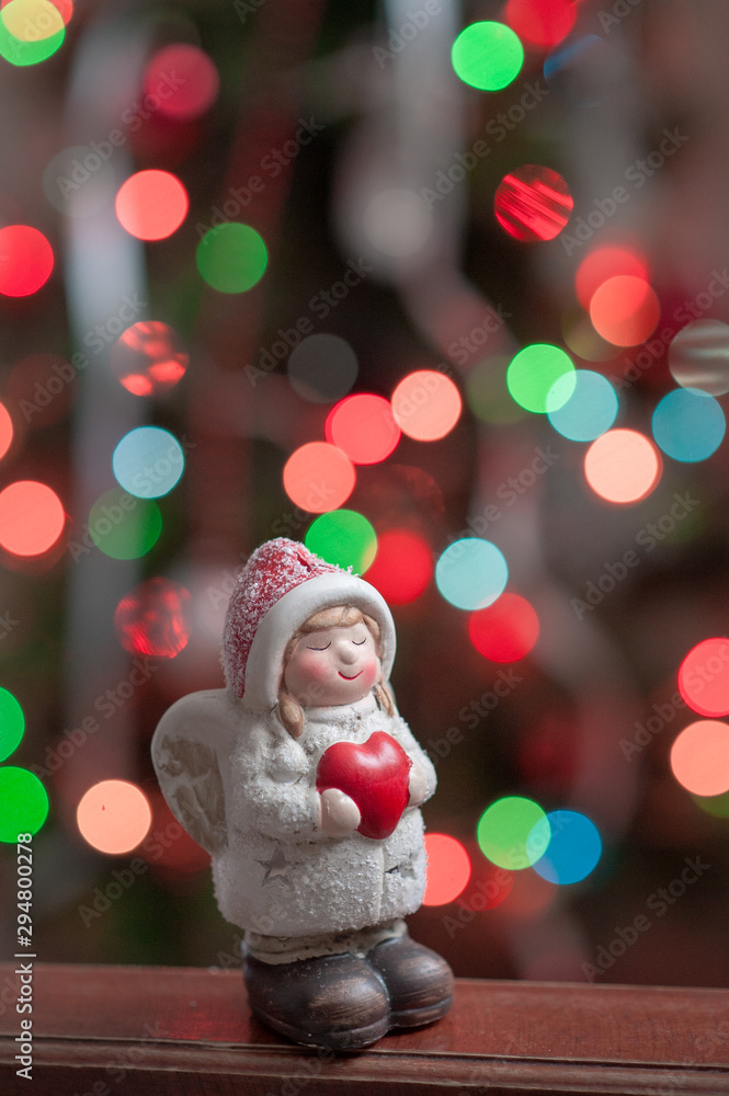 Christmas angel holding a heart in his hands Christmas angel holding a heart in his hands