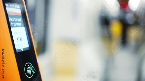 Wallpaper Mural Faceless passenger payment via electronic device in public transport. Detail view female hand with smartwatch on wrist touching modern tram validator for contactless payments at blurred background Torontodigital.ca