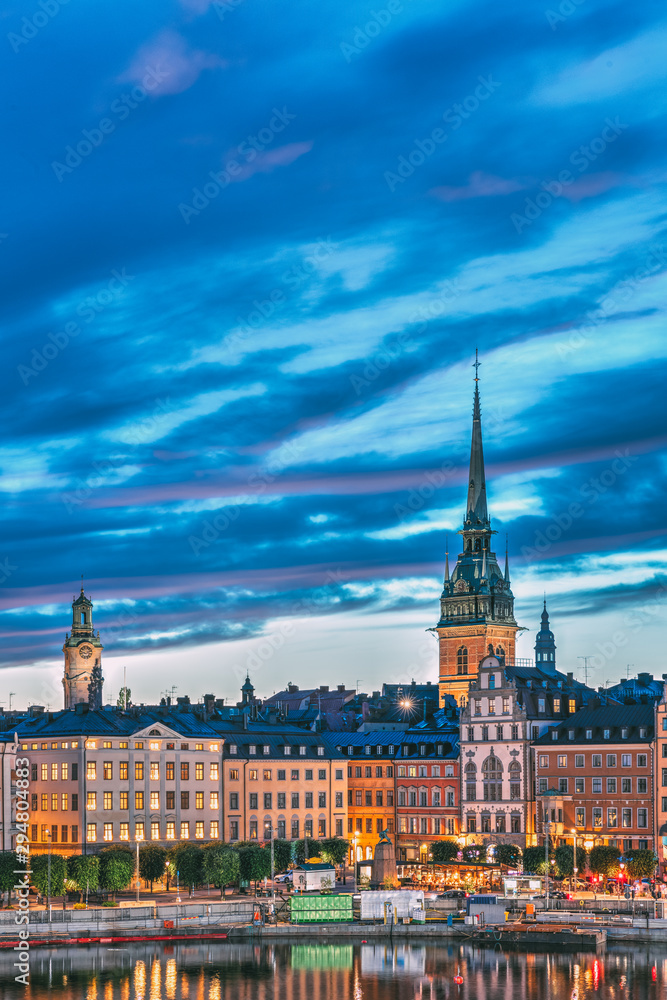 Fototapeta premium Stockholm, Sweden. Scenic View Of Skyline At Evening Night. Tower Of Storkyrkan - The Great Church Or Church Of St. Nicholas And German St Gertrude's Church. Famous Popular Destination In Night