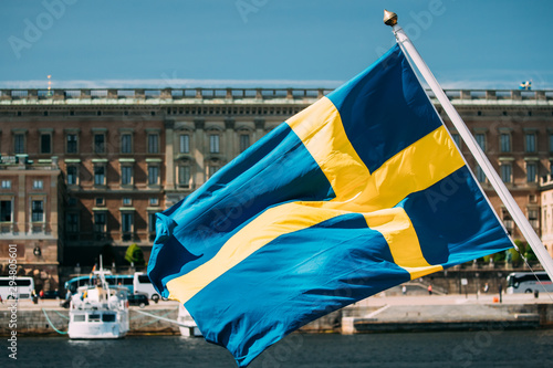 Fotótapéta Stockholm, Sweden. Waving Swedish Flag In Stockholm Street
