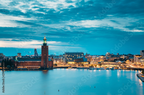 Stockholm, Sweden. Scenic Skyline View Of Famous Tower Of Stockholm City Hall. Building Of Municipal Council. Famous Popular Destination Place In Dusk Lights. Night Lighting