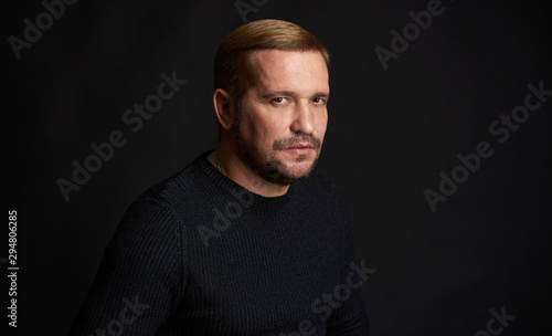 Studio shot of a bearded man on black studio background