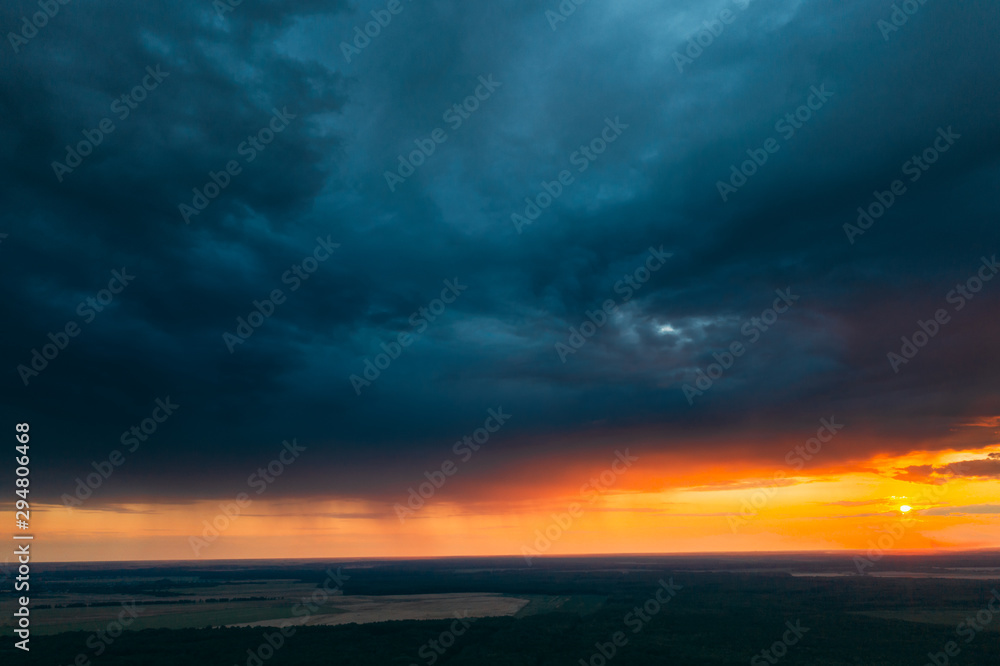 Aerial View Of Sunset Sky Above Green Forest Landscape In Evening. Top View From High Attitude In Summer Sunrise