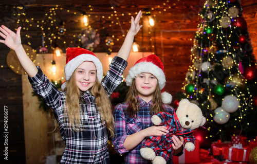 Ready for holiday. Little girl sisters in red hats. We are family. Elf children. Xmas . Santa little girls sisters. Christmas time. Family holiday. Happy sisters. Happy new year. Family party photo