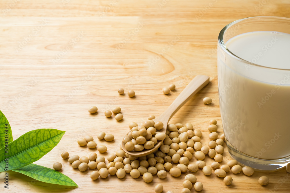 Soy milk and soy bean it on wood table background,healthy concept. Benefits of Soy. Soy milk and soy bean it on wood table background,healthy concept. Benefits of Soy.