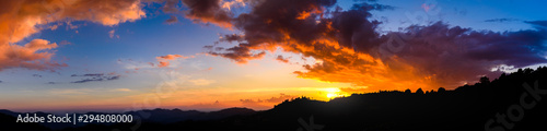 Panoramic landscape of Mountains at sunset with clouds