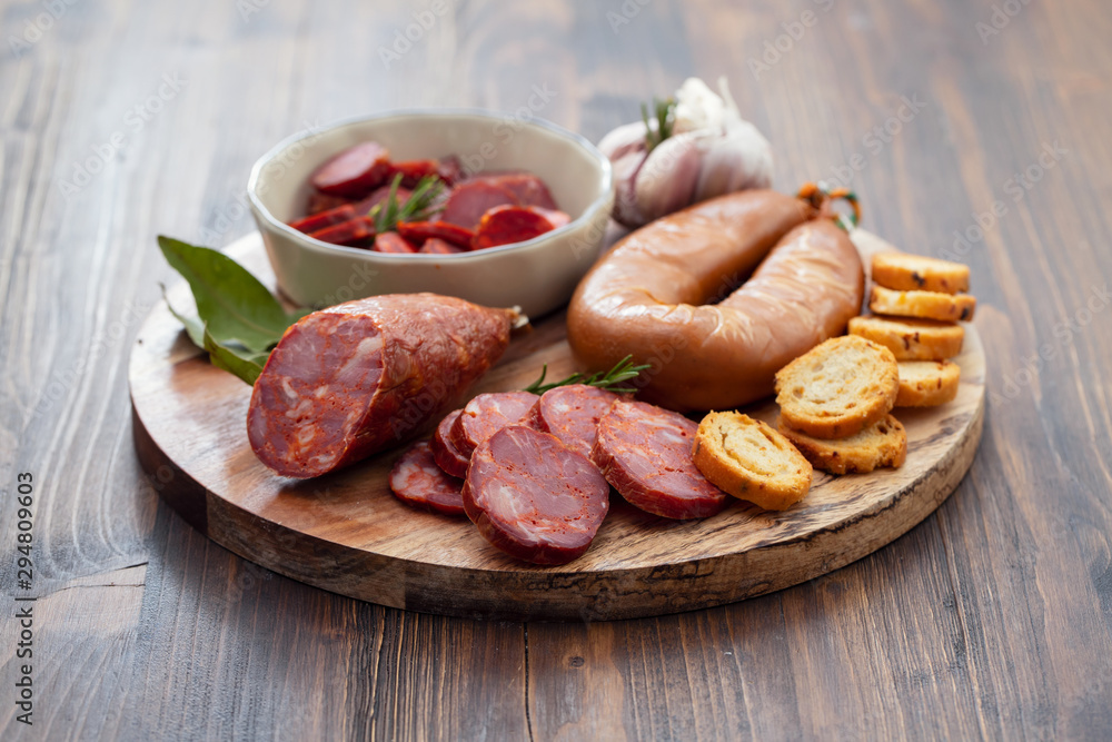 typical smoked portuguese sausages on wooden board typical smoked portuguese sausages on wooden board