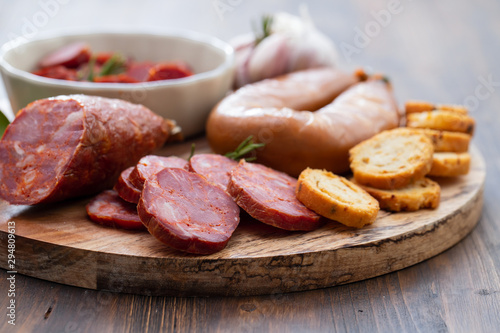 typical smoked portuguese sausages on wooden board