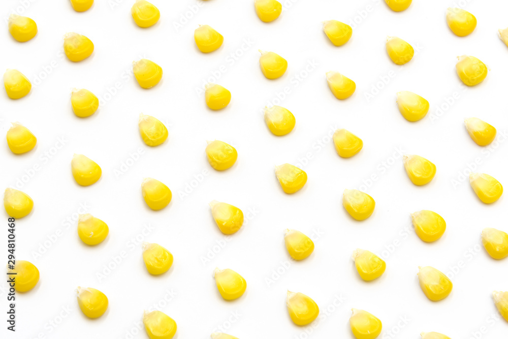 Fresh corn kernels neatly arranged pattern on white background Fresh corn kernels neatly arranged pattern on white background