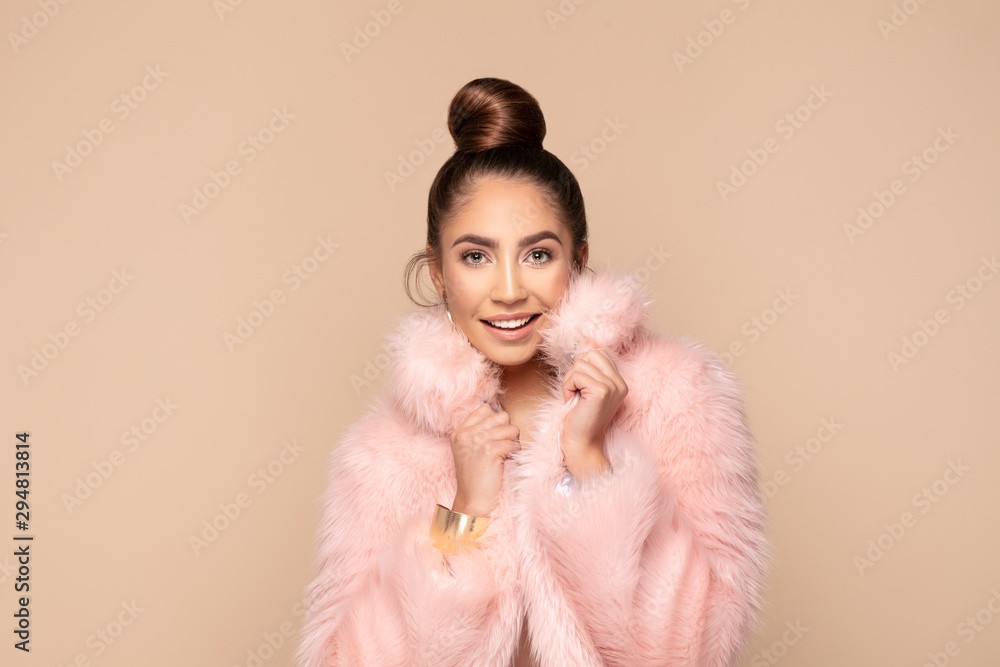Fashionable smiling girl in pink eco fur. Fashionable smiling girl in pink eco fur.