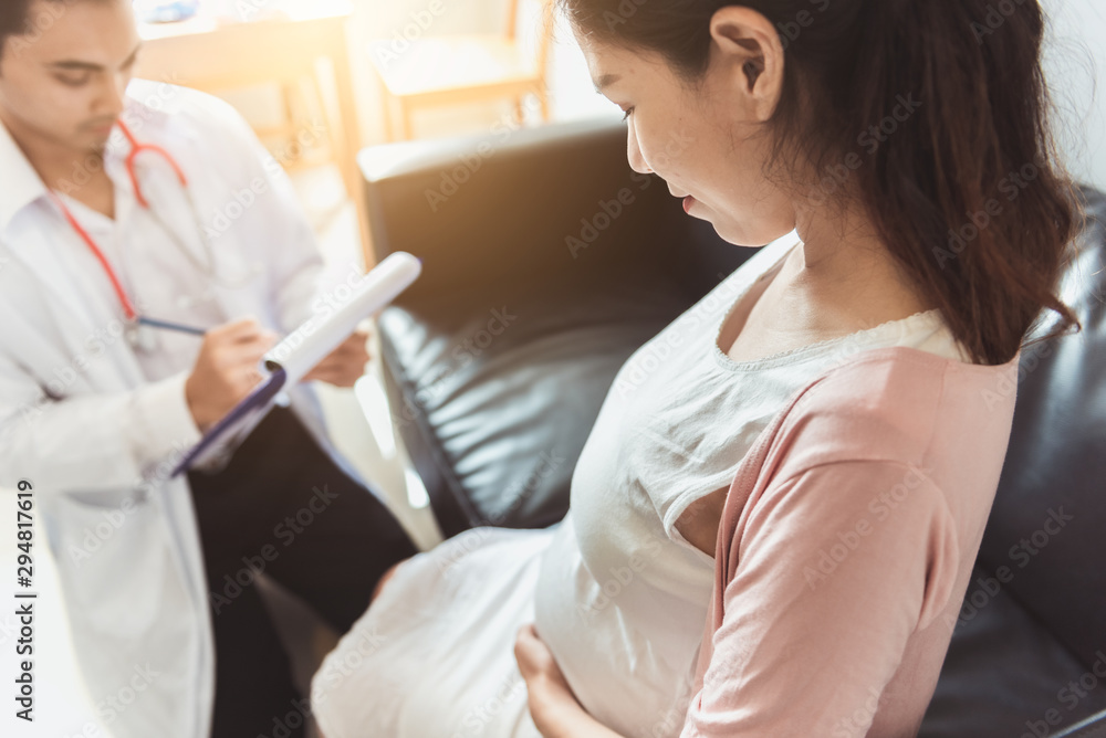 The gynecologist holds a checklist for pregnant women for pregnancy consultant, Doctor examine pregnant belly and mother healthcare check up, Gynecology concept. The gynecologist holds a checklist for pregnant women for pregnancy consultant, Doctor examine pregnant belly and mother healthcare check up, Gynecology concept.