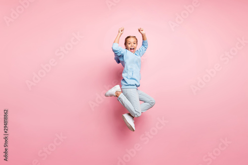 Full body profile photo of pretty small lady jumping high celebrating best sportive competition victory wear casual outfit isolated pastel pink color background