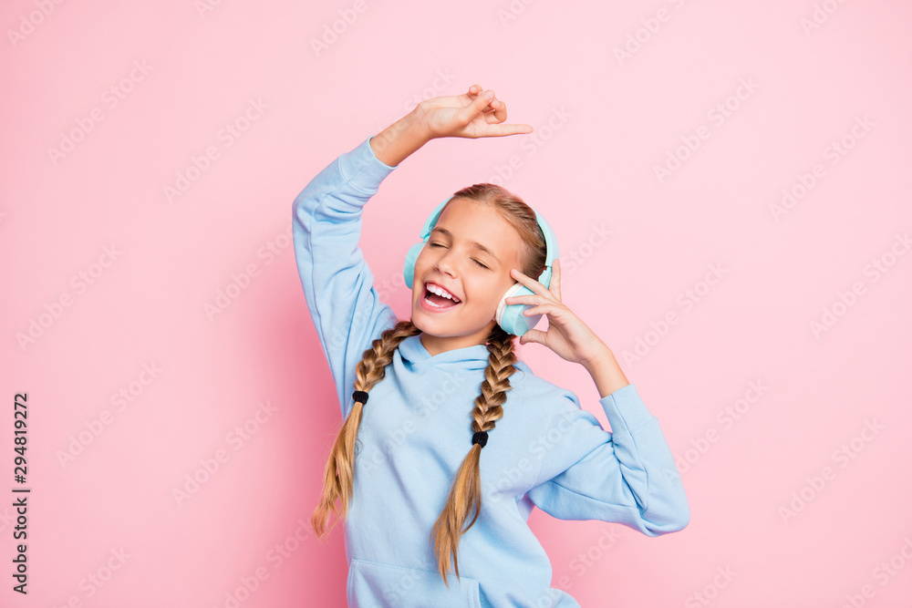 Photo of blonde haired cheerful positive cute nice singing girl dancing with her favorite song in headphones isolated over pink pastel color background Photo of blonde haired cheerful positive cute nice singing girl dancing with her favorite song in headphones isolated over pink pastel color background