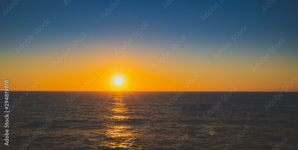 sunset over the ocean with an endless horizon 