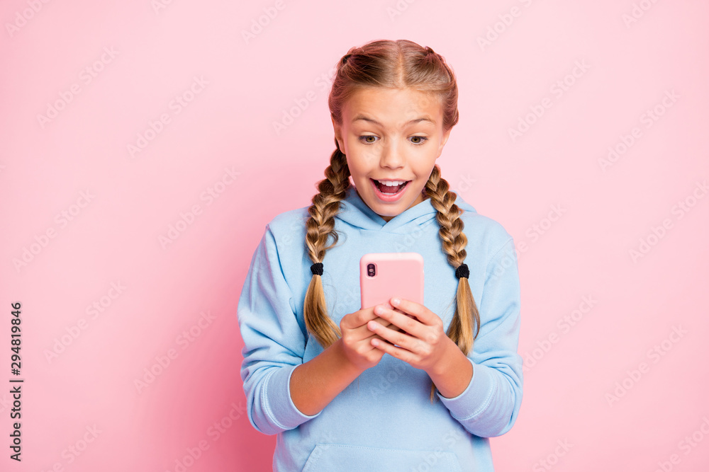 Photo of stylish trendy casual white cheerful nice cute girl using telephone to read feednews and browse through social media isolated over pastel color background Photo of stylish trendy casual white cheerful nice cute girl using telephone to read feednews and browse through social media isolated over pastel color background