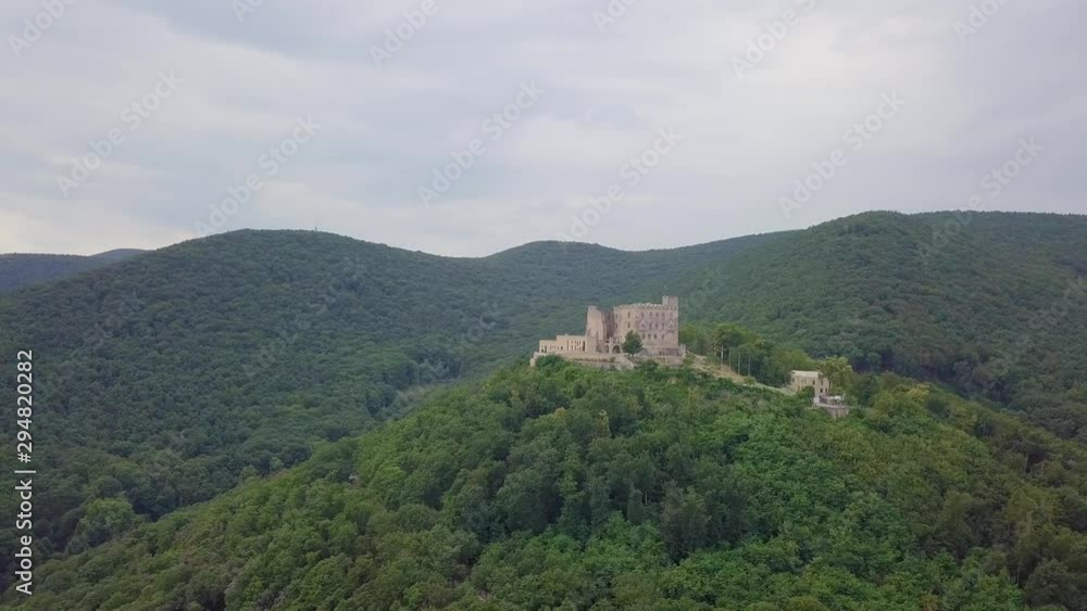 Mountains covered in trees on the background of a big medieval castle, 4k Mountains covered in trees on the background of a big medieval castle, 4k