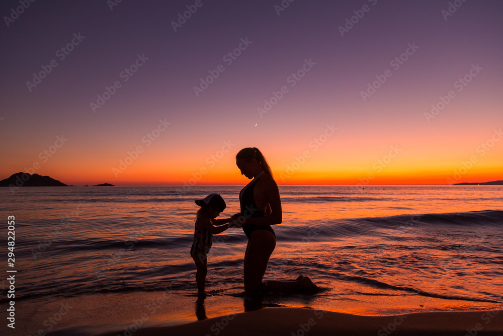 Mother and daughter at the sea