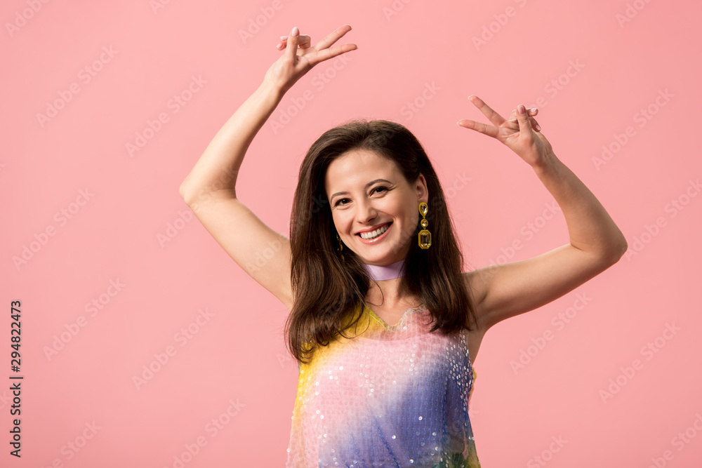 happy young stylish disco girl showing peace sign isolated on pink happy young stylish disco girl showing peace sign isolated on pink