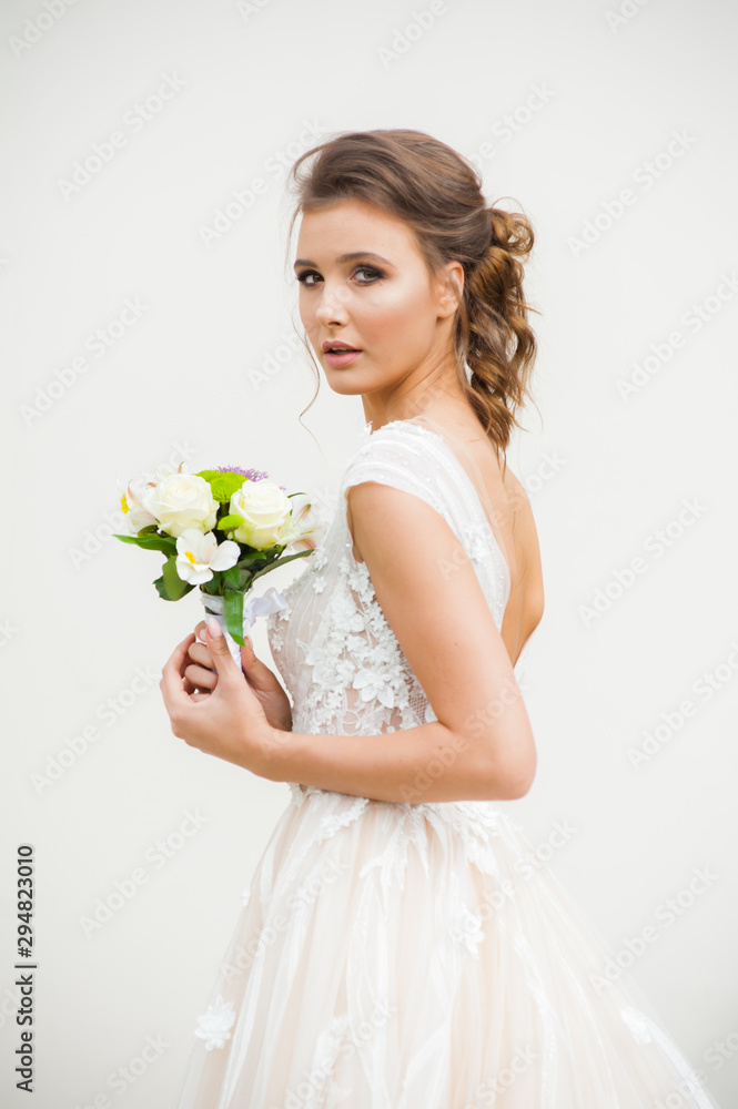 Beautiful bride holding a bouquet before getting married Beautiful bride holding a bouquet before getting married