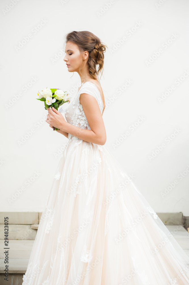 Bride in long wedding dress with bouquet outdoor Bride in long wedding dress with bouquet outdoor