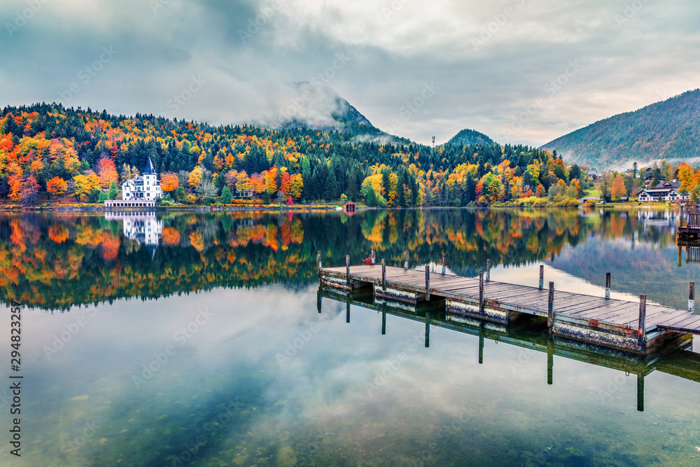 Foggy autumn view of Grundlsee lake. Wonderful morning scene of Brauhof village, Styria stare of Austria, Europe. Colorful view of Alps. Traveling concept background.