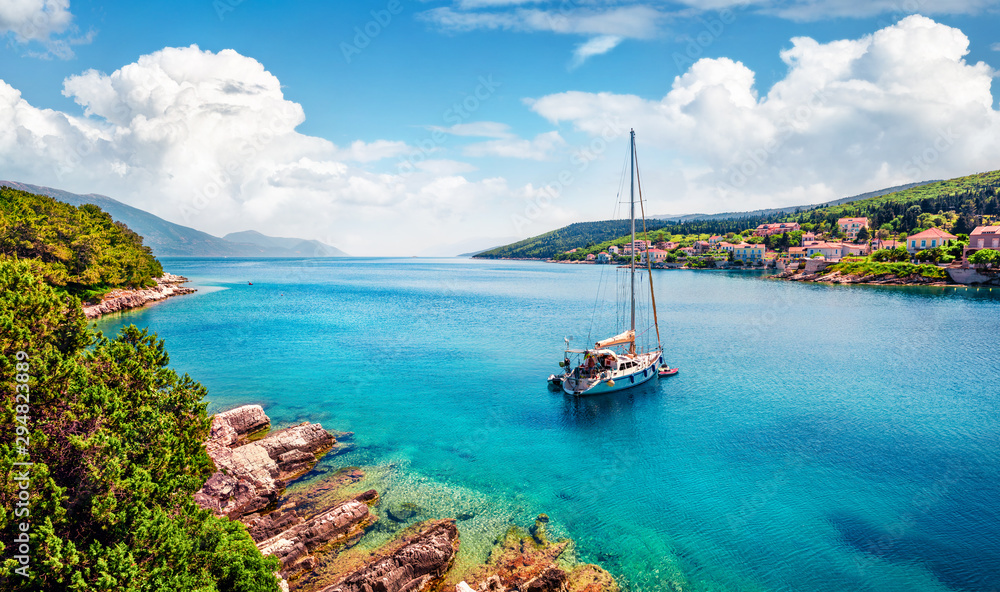 Marvelous summer view of Fiskardo port. Stunning morning seascape of Ionian Sea. Picturesque morning scene of Kefalonia island, Greece, Europe. Traveling concept background.