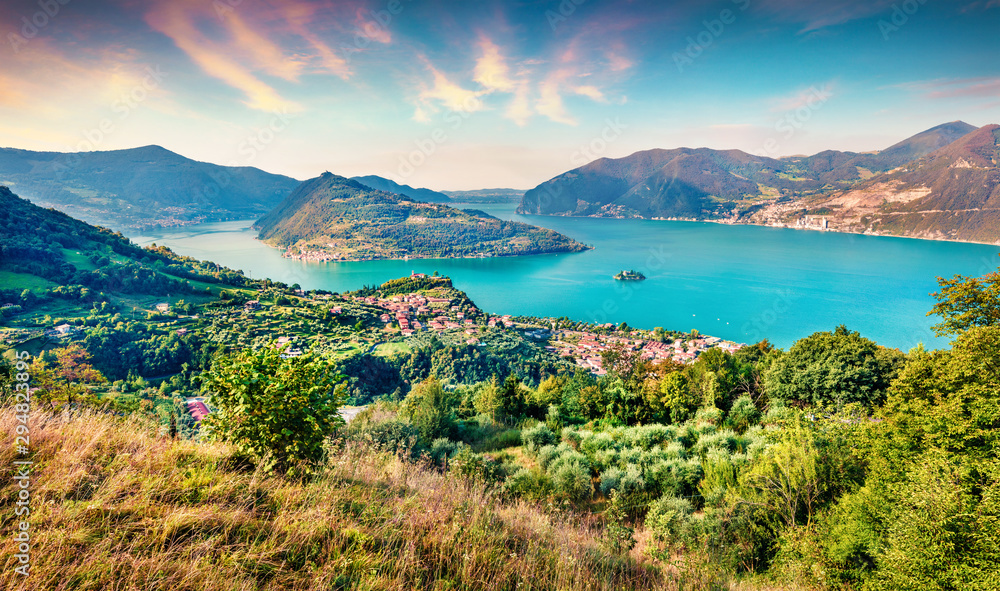 Aerial summer view of Iseo lake. Bright morning cityscape of Marone town with Monte Isola island, Province of Brescia, Italy, Europe. Traveling concept background.