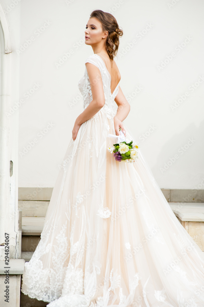 Beautiful bride holding a bouquet before getting married Beautiful bride holding a bouquet before getting married