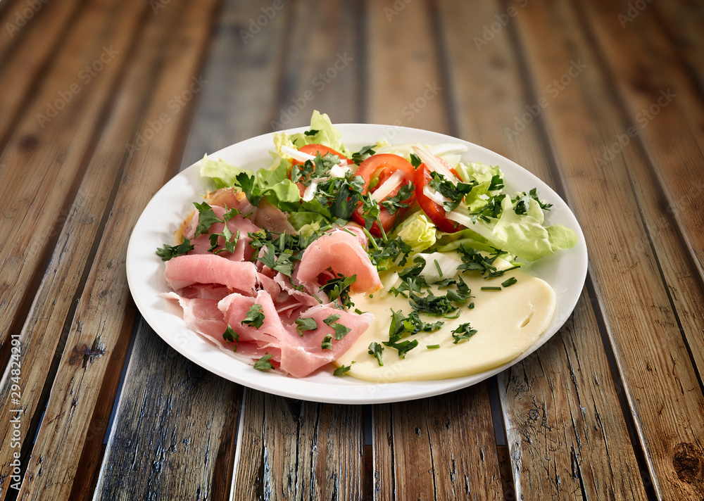 Vegetables on plate and wooden textured table Vegetables on plate and wooden textured table