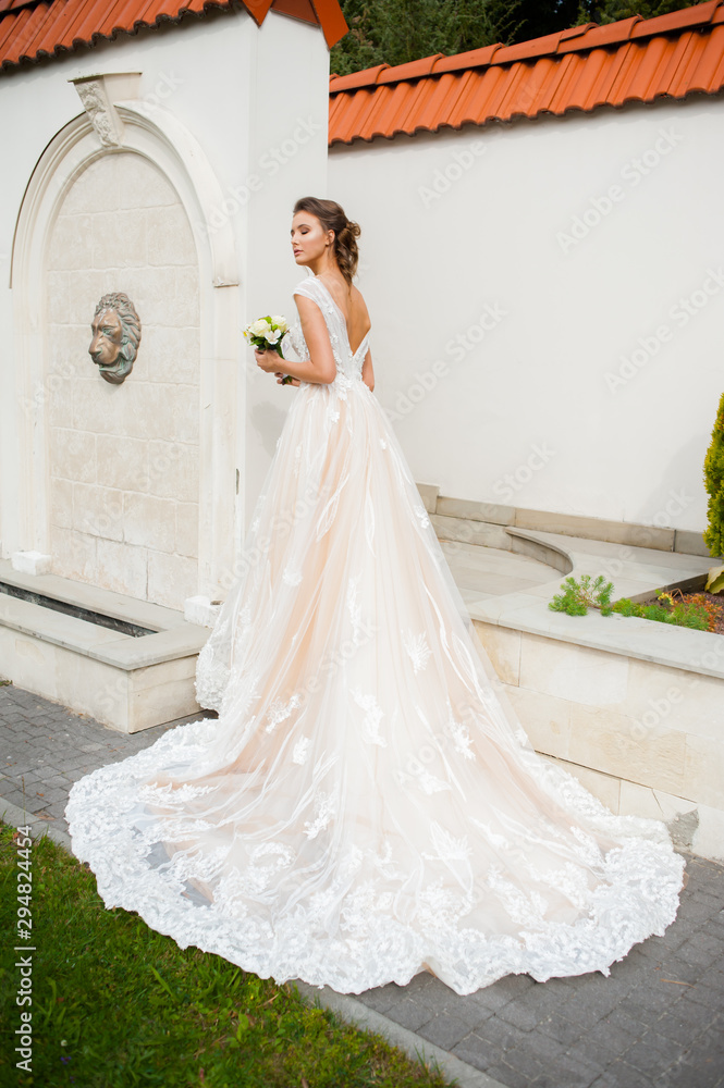 Beautiful  bride in long wedding dress with bouquet