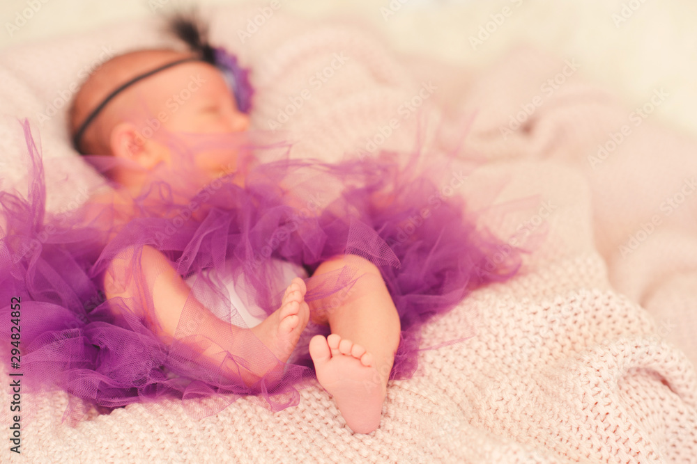 Sleeping baby girl 1-2 months old lying in bed closeup. Good morning. Healthy little child nap. Focus on feet. Sleeping baby girl 1-2 months old lying in bed closeup. Good morning. Healthy little child nap. Focus on feet.
