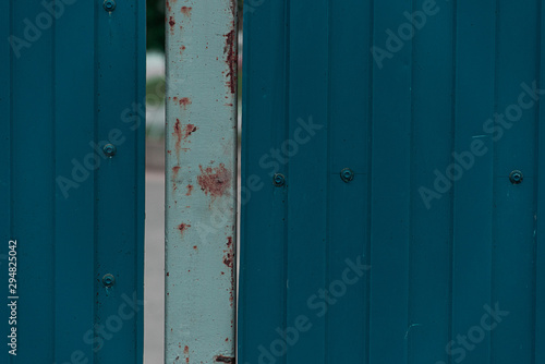 Old corrugated blue metal fence © savelov