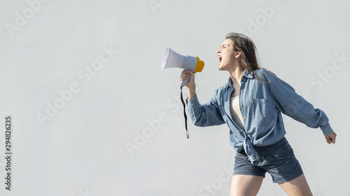 Activist with megaphone shouting at demonstration photo
