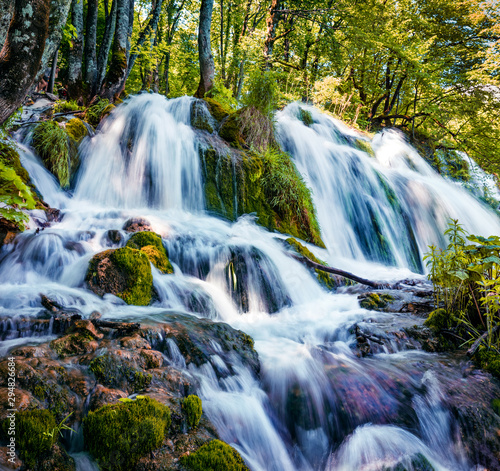 Stunning morning view of pure water waterfall on Plitvice National Park. Colorful spring scene of green forest. Splendid countryside view of Croatia, Europe. Beauty of nature concept background.